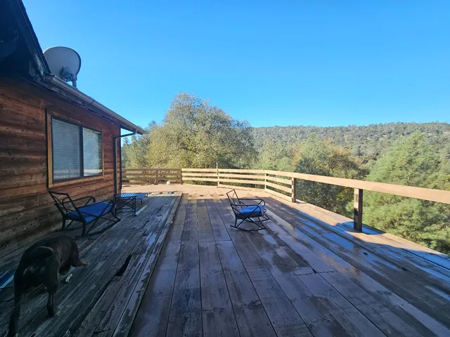 a view of balcony with wooden floor and fence