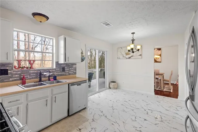 a large white kitchen with a window