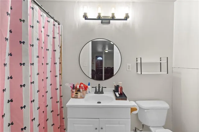 a bathroom with a sink mirror and toilet