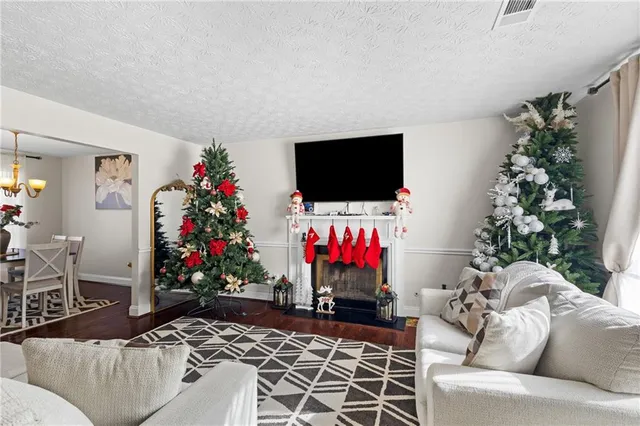 a living room with furniture and flowers