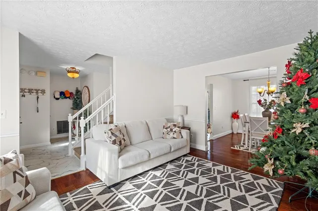 a living room with furniture and flowers