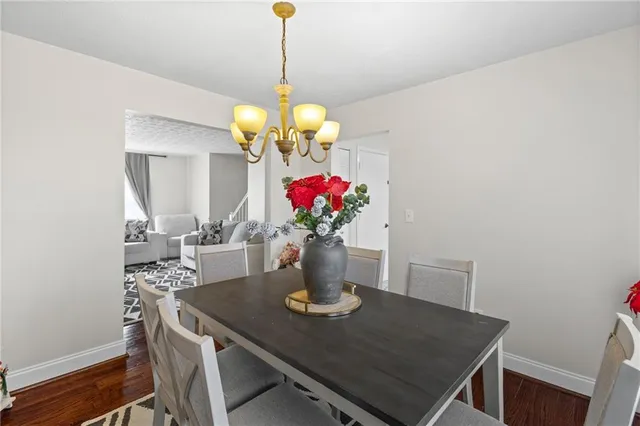 a view of a dining room with furniture and chandelier