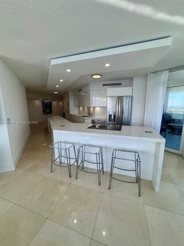 a large kitchen with a table and chairs