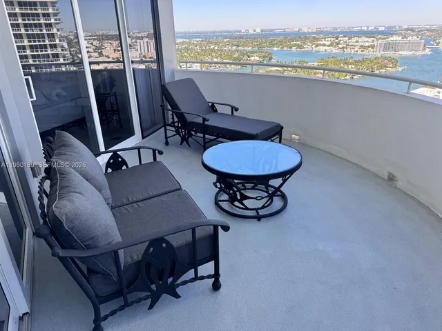 a view of a livingroom with furniture window and wooden floor