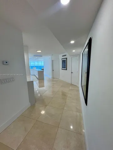 a view of livingroom with painted wall and a window