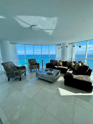 a living room with furniture and a mirror