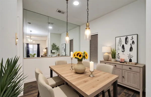 a view of a dining room and livingroom with furniture wooden floor a chandelier