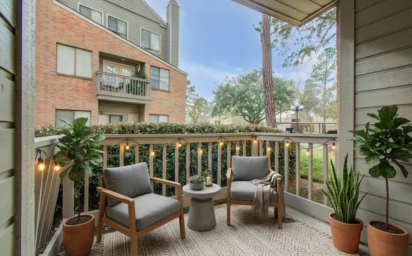 a view of balcony with furniture