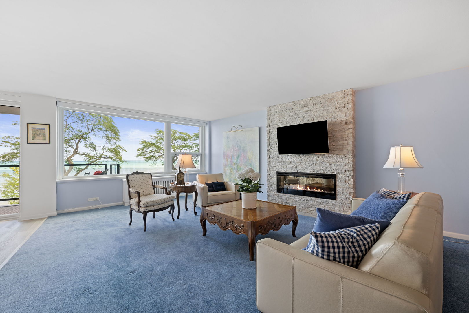 1630 Sheridan Road, Unit 2F Wilmette, IL 60091 - Photo 11 of 25 a living room with furniture a fireplace and a flat screen tv