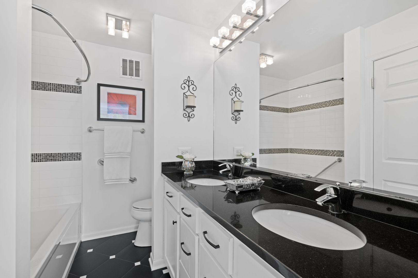 1630 Sheridan Road, Unit 2F Wilmette, IL 60091 - Photo 16 of 25 a bathroom with a granite countertop sink a mirror a toilet and a shower