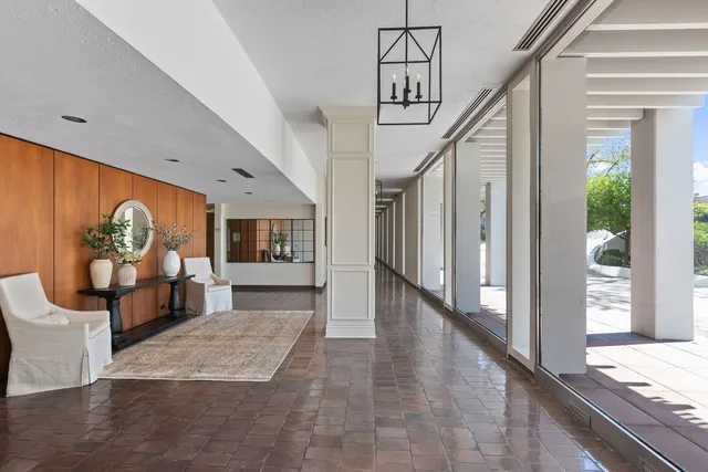 a view of a hallway with wooden floor and furniture