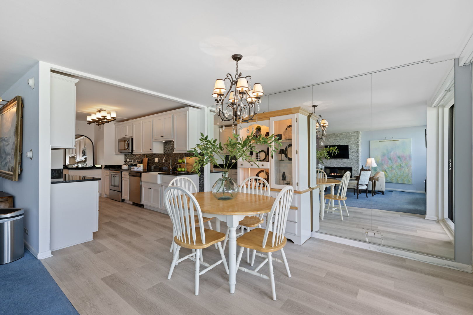 1630 Sheridan Road, Unit 2F Wilmette, IL 60091 - Photo 6 of 25 a dining room with wooden floor a chandelier a wooden table and chairs