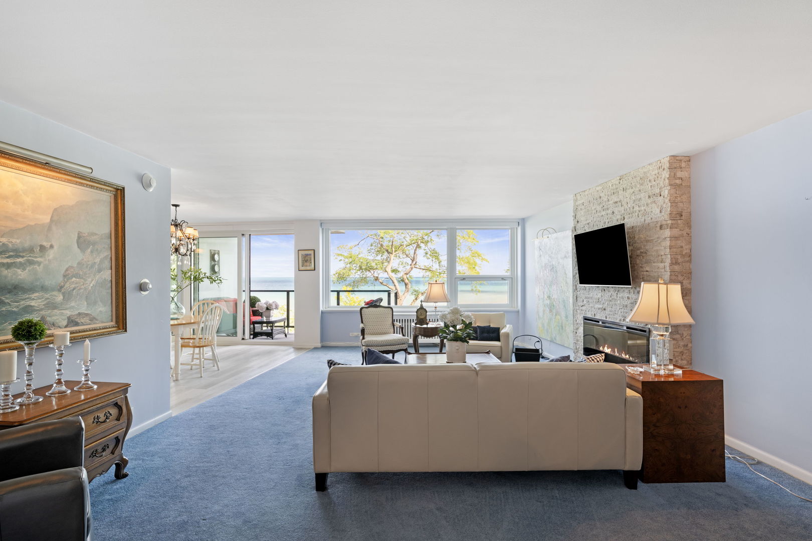 1630 Sheridan Road, Unit 2F Wilmette, IL 60091 - Photo 8 of 25 a living room with furniture a flat screen tv and a large window