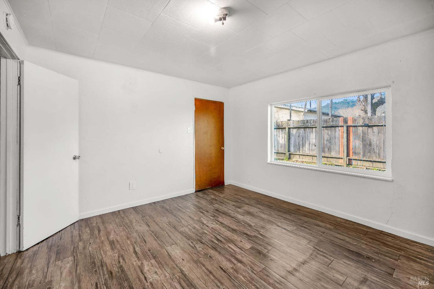 160 Thomas Street Ukiah, CA 95482 - Photo 13 of 26 a view of empty room with wooden floor and fan