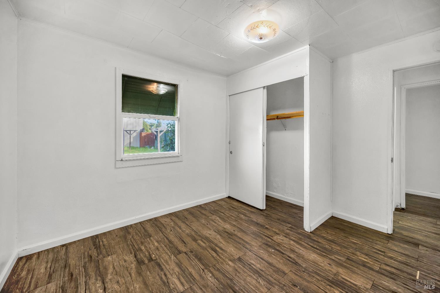 160 Thomas Street Ukiah, CA 95482 - Photo 15 of 26 an empty room with wooden floor and windows