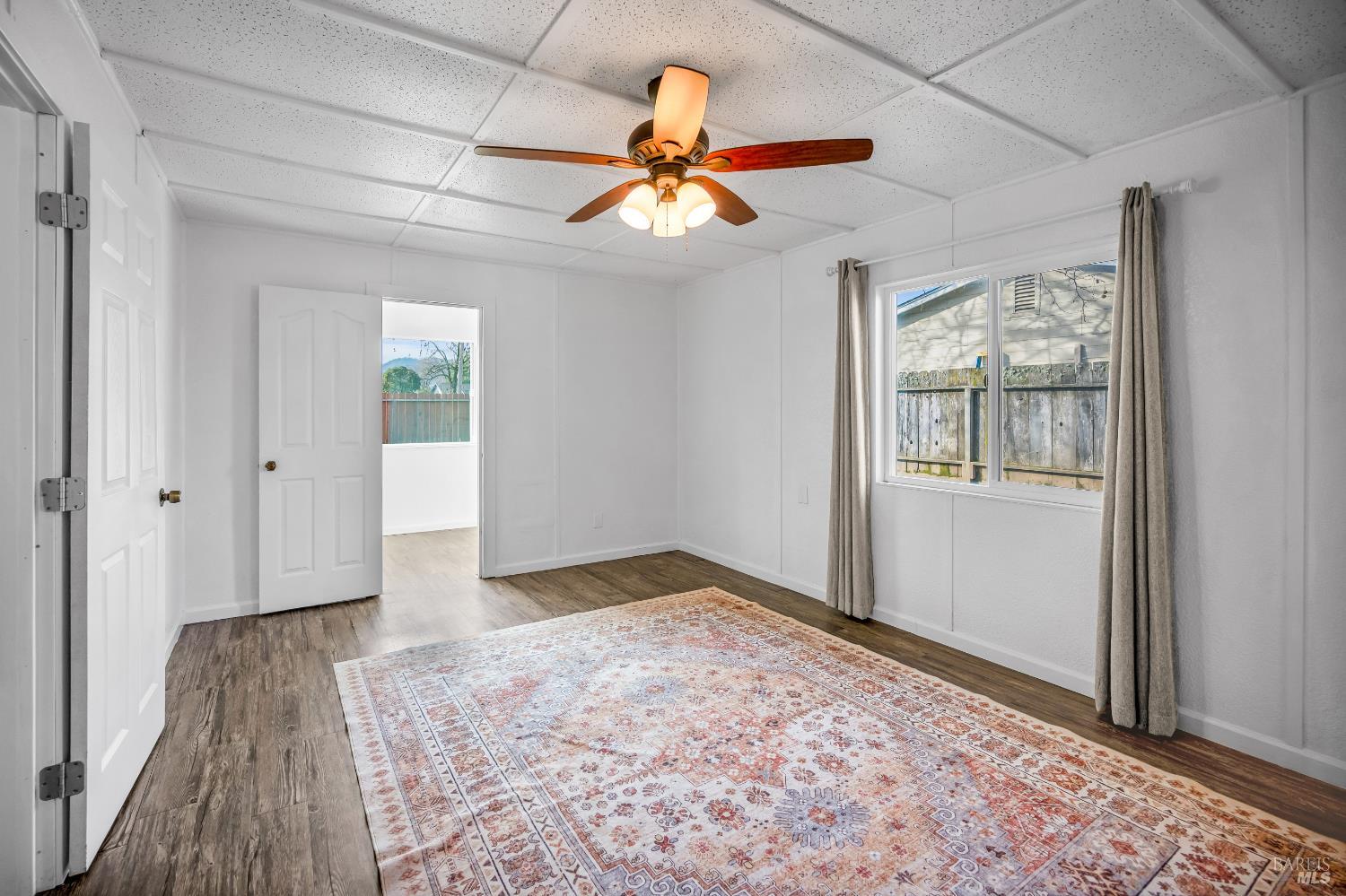 160 Thomas Street Ukiah, CA 95482 - Photo 6 of 26 wooden floor in an empty room with a window