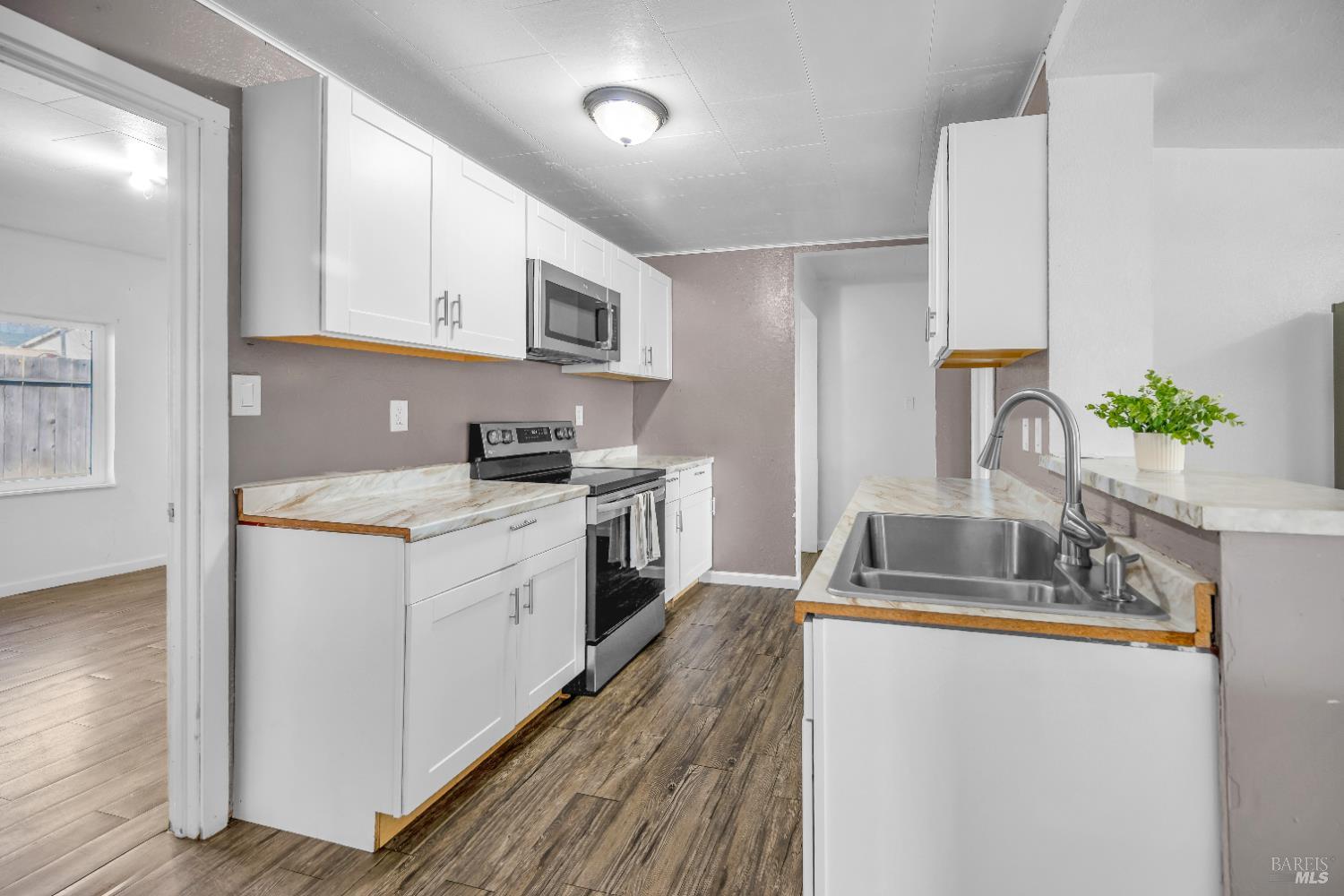 160 Thomas Street Ukiah, CA 95482 - Photo 8 of 26 a kitchen with granite countertop a sink stainless steel appliances and cabinets