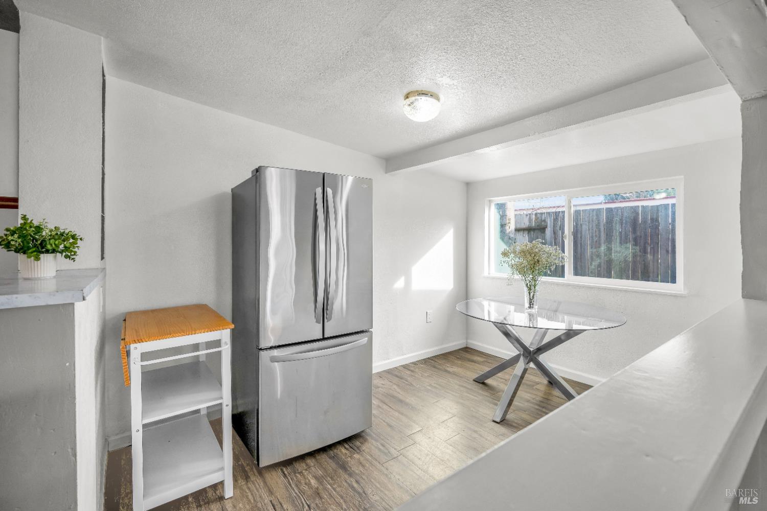 160 Thomas Street Ukiah, CA 95482 - Photo 10 of 26 a kitchen with a refrigerator a stove and a dining table