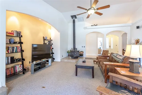 a living room with furniture a flat screen tv and a large window
