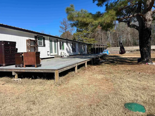 a view of a house with pool and sitting area