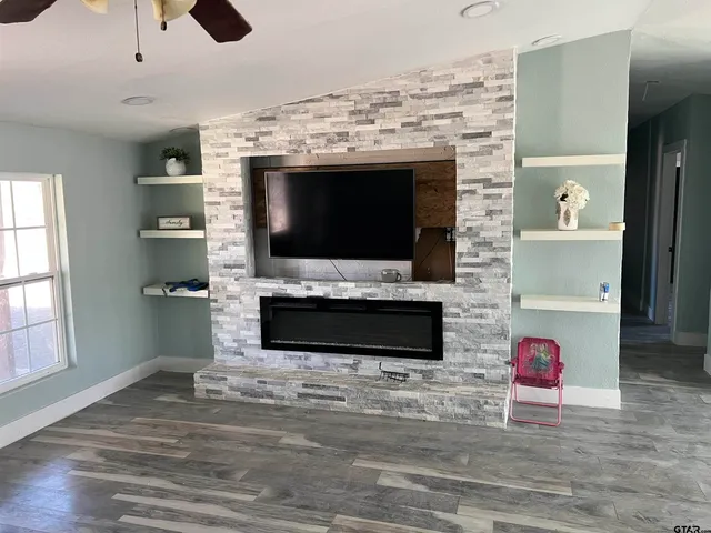 a living room with a flat screen tv and a fireplace