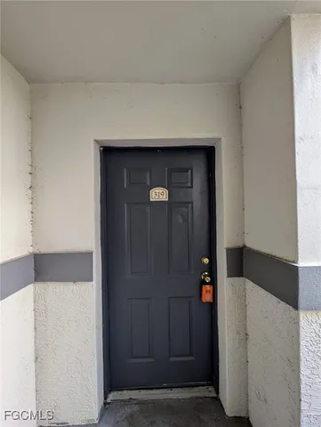 a hallway with sliding door and wooden floor