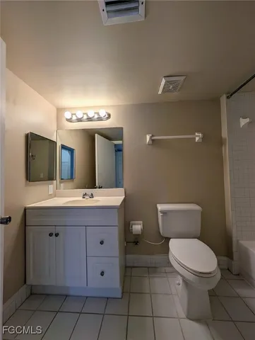 a white toilet sitting next to a bath tub and a shower