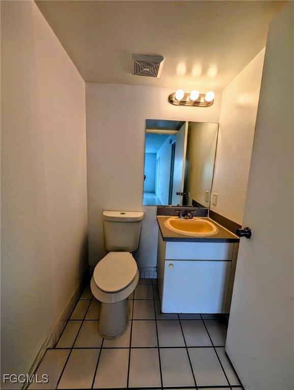 3407 Winkler Avenue, Unit 319 Fort Myers, FL 33916 - Photo 17 of 18 a bathroom with a toilet a sink and mirror