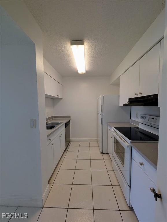 3407 Winkler Avenue, Unit 319 Fort Myers, FL 33916 - Photo 9 of 18 a kitchen with granite countertop a stove a sink and a refrigerator