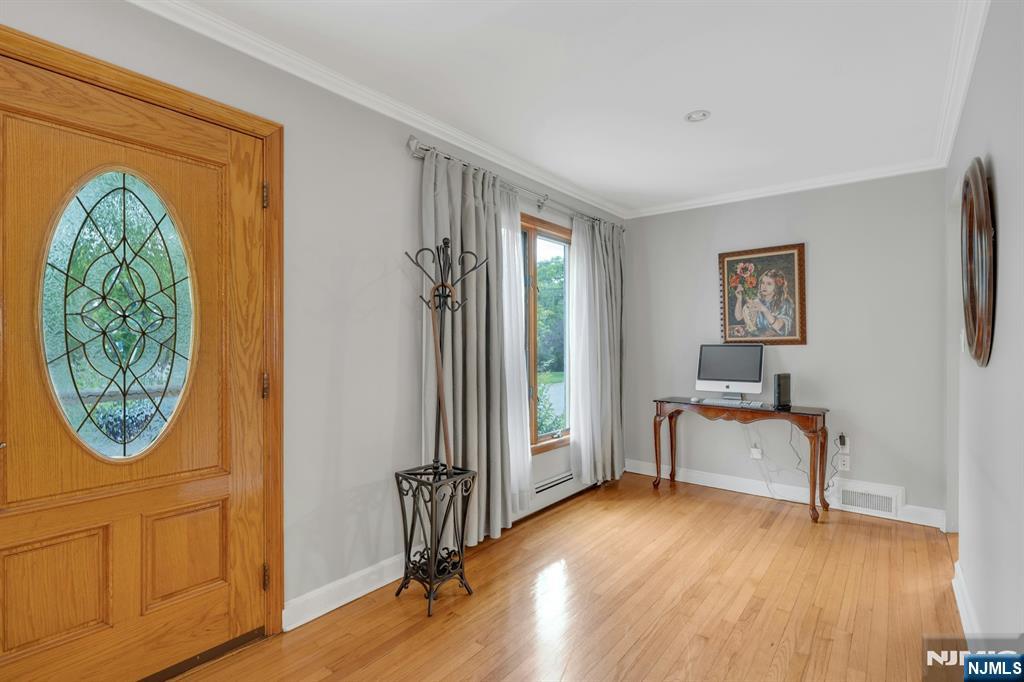 24 Cambridge Road Tenafly, NJ 07670 - Photo 4 of 31 a view of a hallway with entryway wooden floor and front door