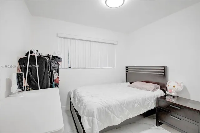 a bed room with a bed and a window