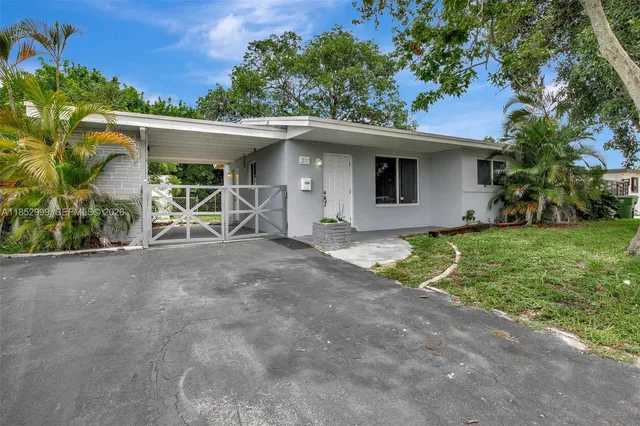 a view of a house with a yard and garage