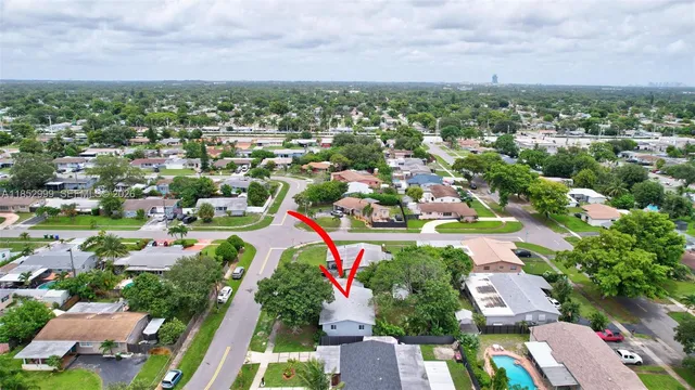an aerial view of residential houses with outdoor space and swimming pool