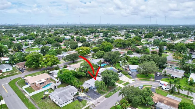 an aerial view of residential houses with outdoor space and street view
