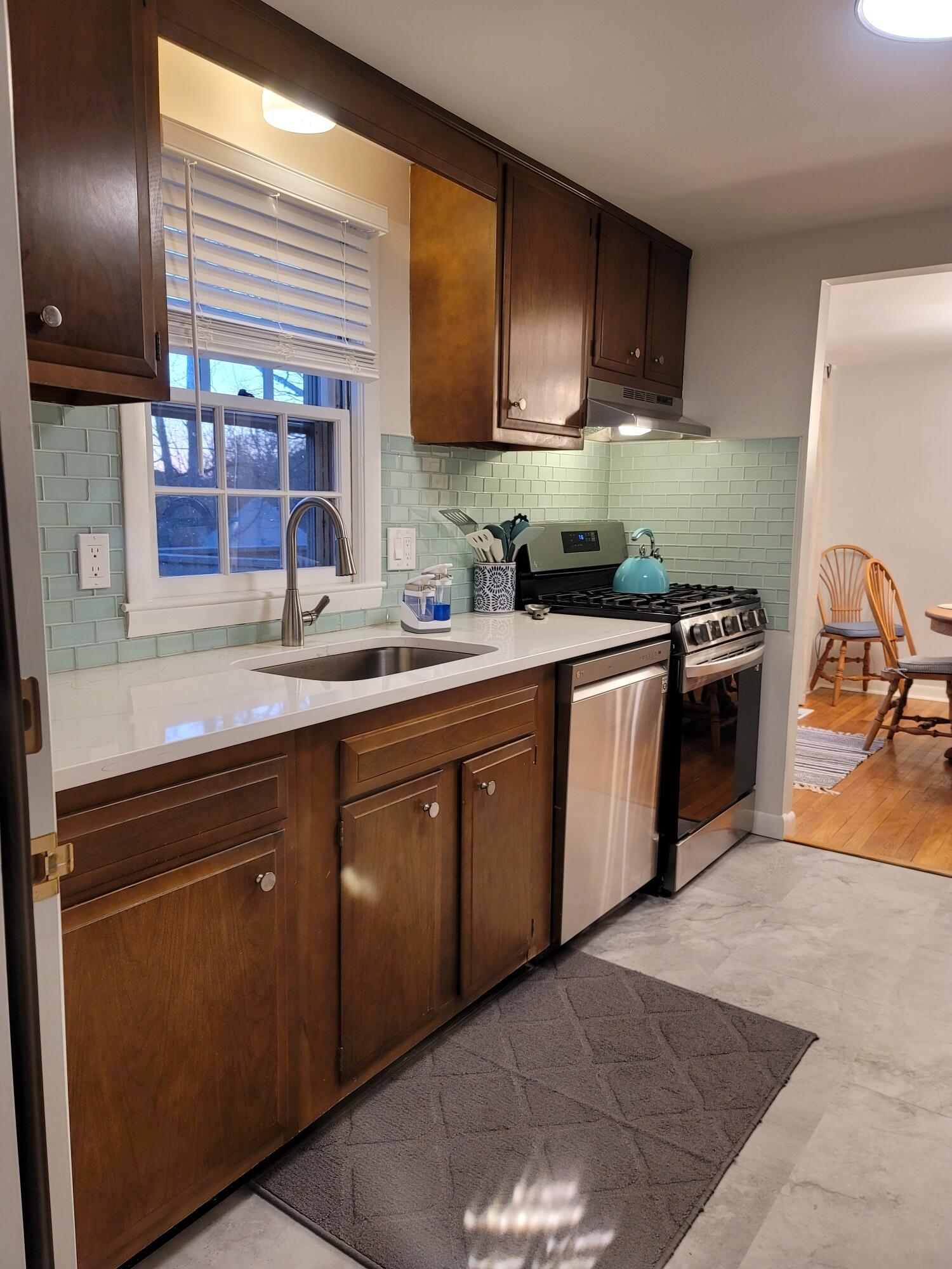 7 Jonquil Road Yarmouth Port, MA 02675 - Photo 5 of 16 a kitchen with a sink stove and cabinets