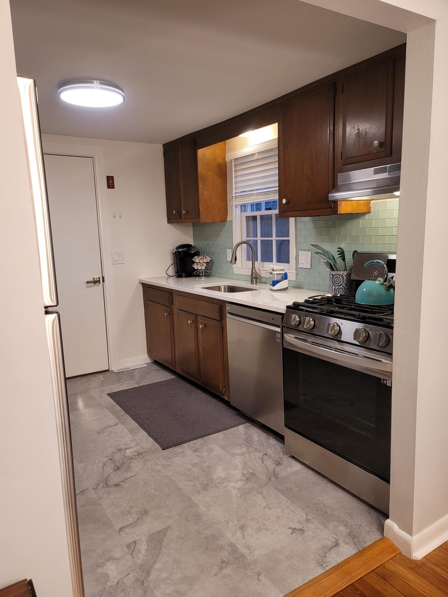 7 Jonquil Road Yarmouth Port, MA 02675 - Photo 6 of 16 a kitchen with stainless steel appliances granite countertop a stove a sink and a refrigerator