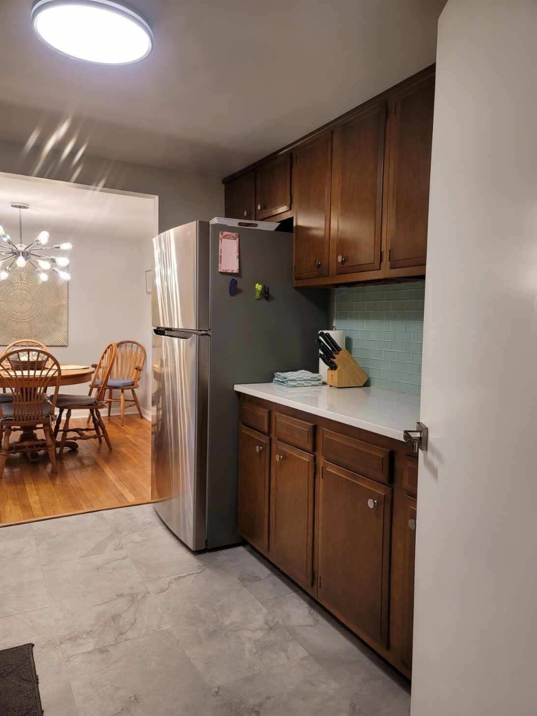 7 Jonquil Road Yarmouth Port, MA 02675 - Photo 7 of 16 a kitchen with sink refrigerator and cabinets