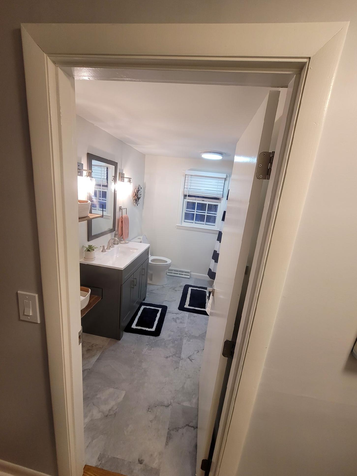 7 Jonquil Road Yarmouth Port, MA 02675 - Photo 8 of 16 a bathroom with a sink a toilet a mirror and vanity