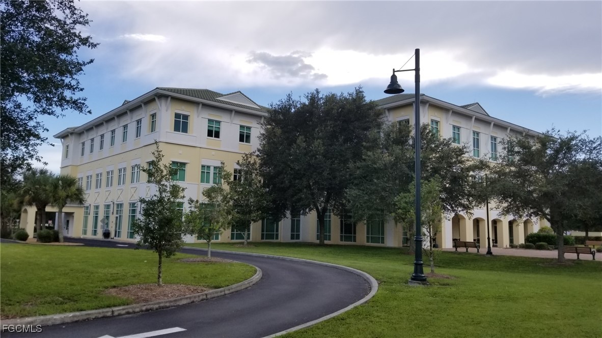 1147203405 Whaling Road North Port, FL 34288 - Photo 4 of 41 a front view of a house with a garden and trees