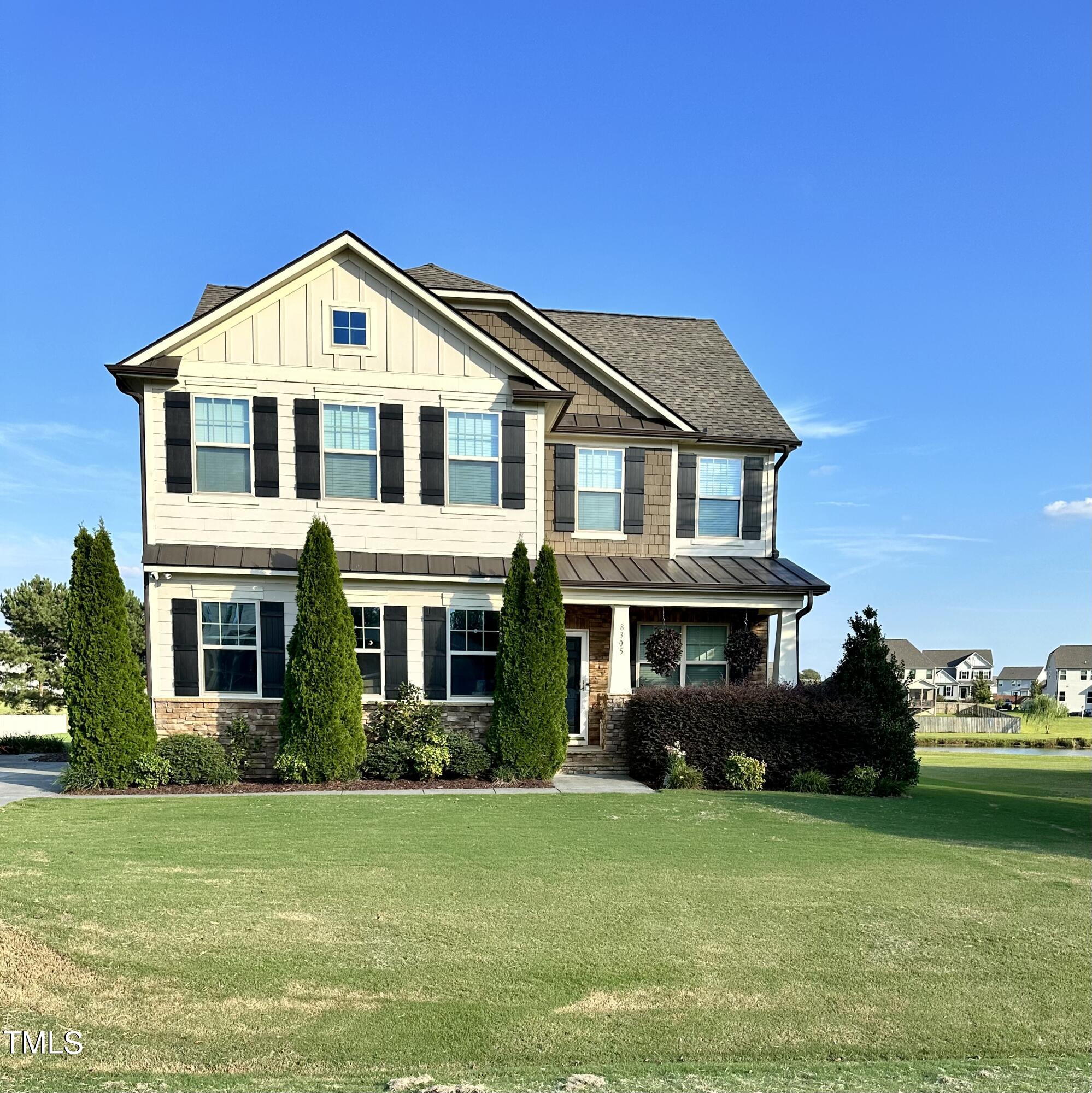 a front view of a house with a garden