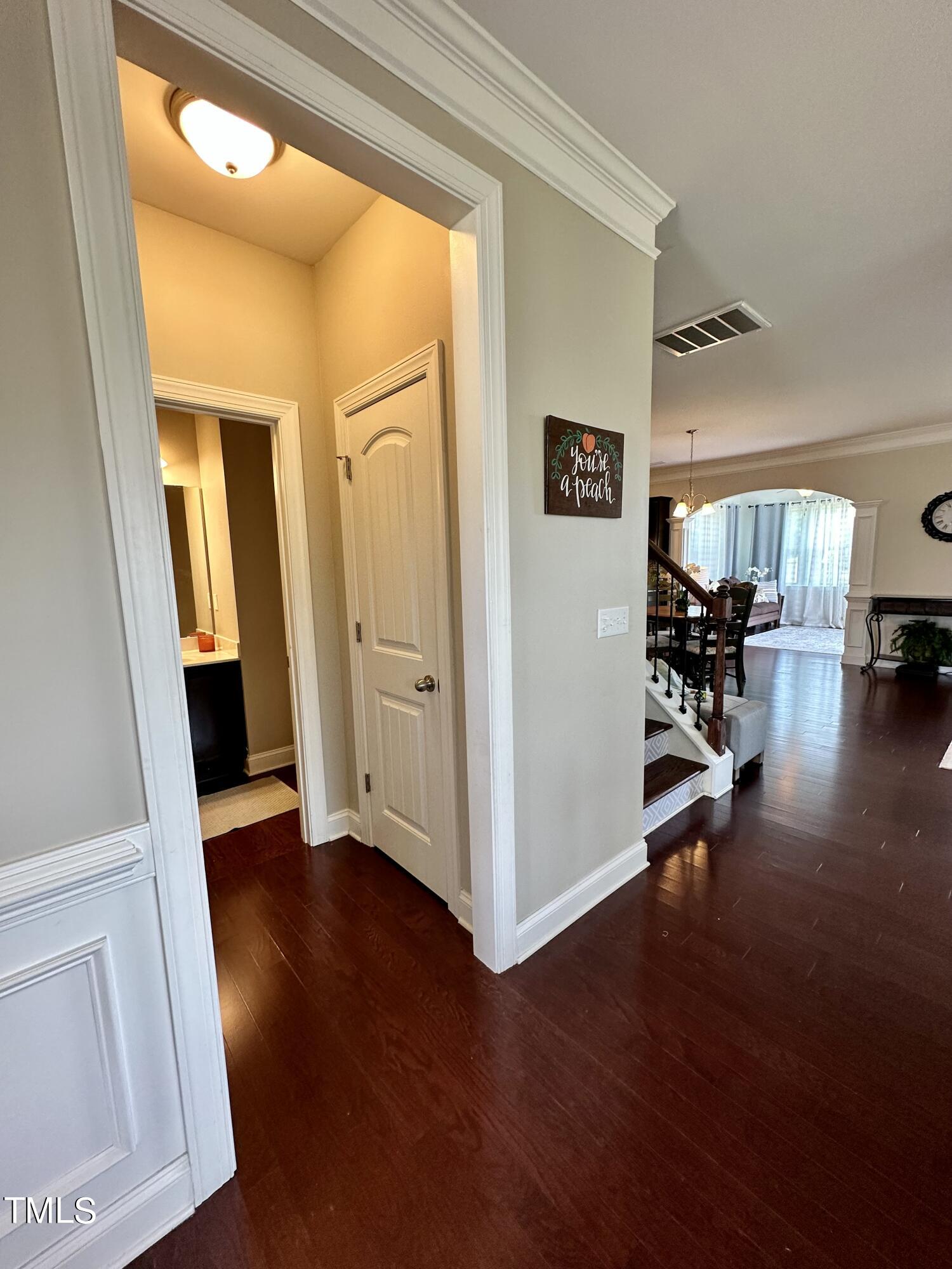 8305 Pin Cherry Drive Willow Spring, NC 27592 - Photo 11 of 60 a view of a hallway view with wooden floor and furniture