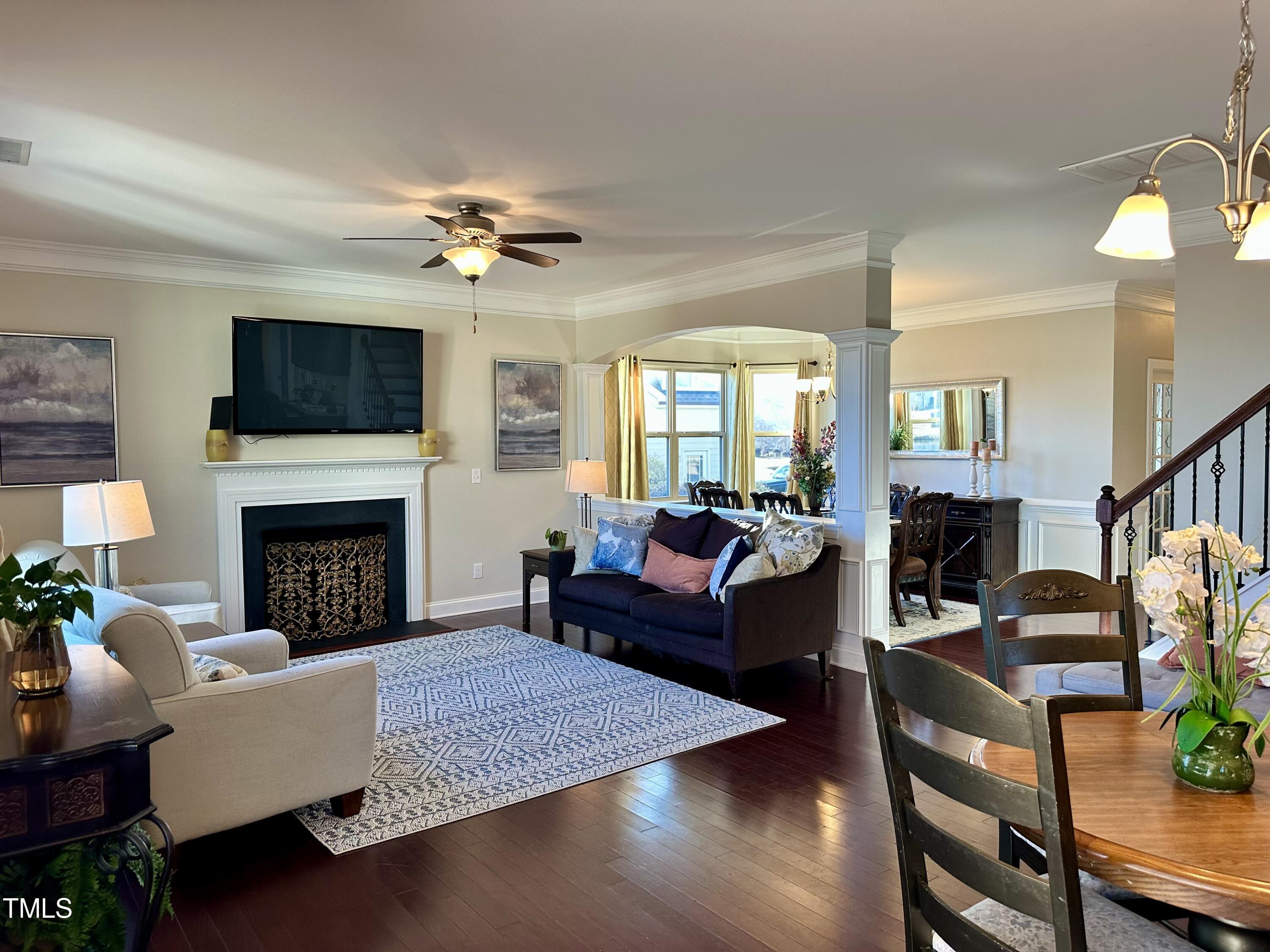 8305 Pin Cherry Drive Willow Spring, NC 27592 - Photo 15 of 60 a living room with furniture a flat screen tv and a fireplace