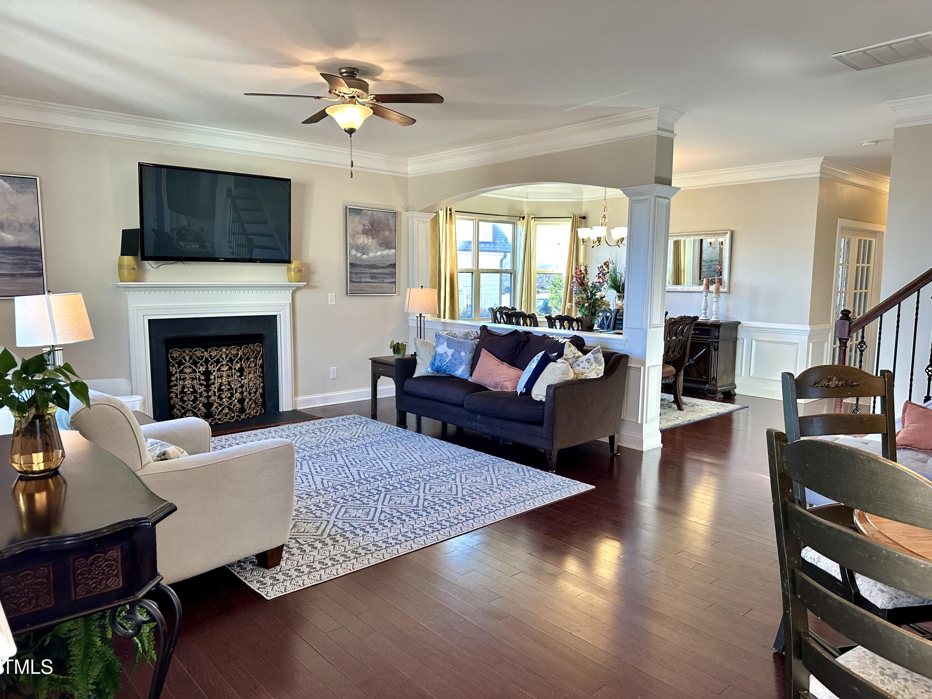 8305 Pin Cherry Drive Willow Spring, NC 27592 - Photo 17 of 60 a living room with furniture fireplace and flat screen tv