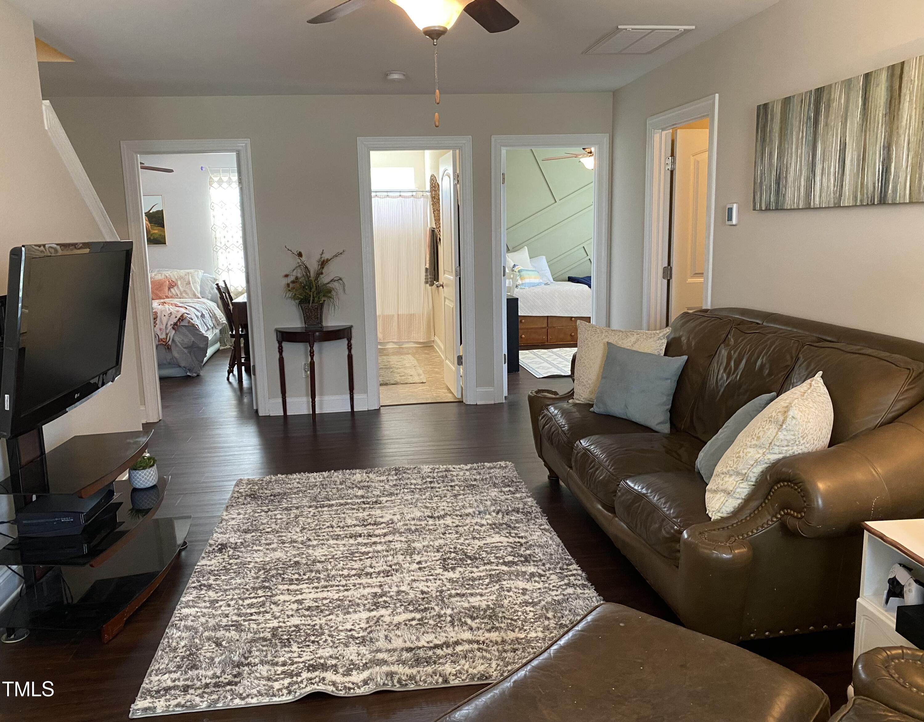 8305 Pin Cherry Drive Willow Spring, NC 27592 - Photo 31 of 60 a living room with furniture and a flat screen tv