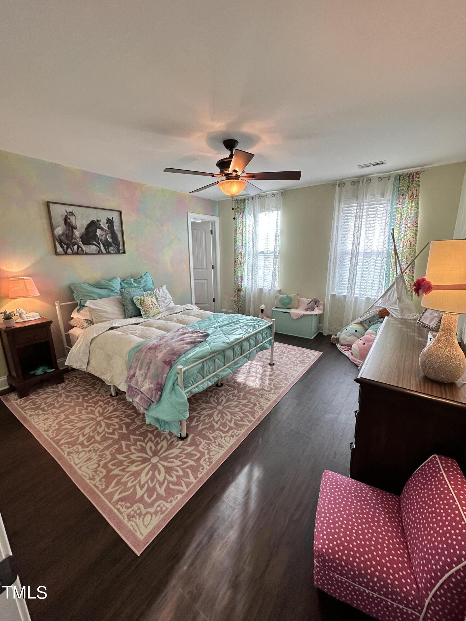 8305 Pin Cherry Drive Willow Spring, NC 27592 - Photo 34 of 60 a bedroom with a large bed and a couch