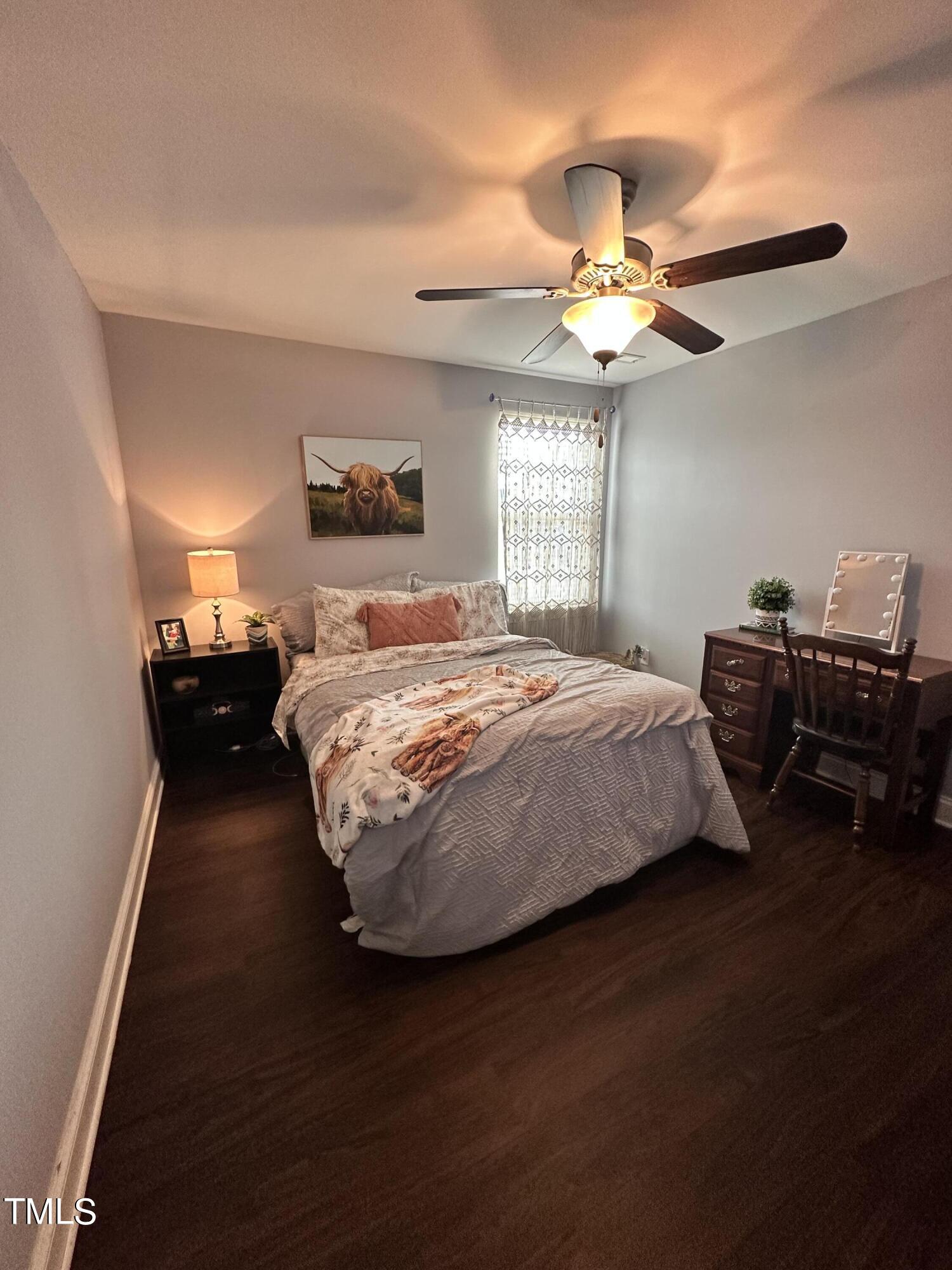 8305 Pin Cherry Drive Willow Spring, NC 27592 - Photo 35 of 60 a bedroom with a bed and a chandelier