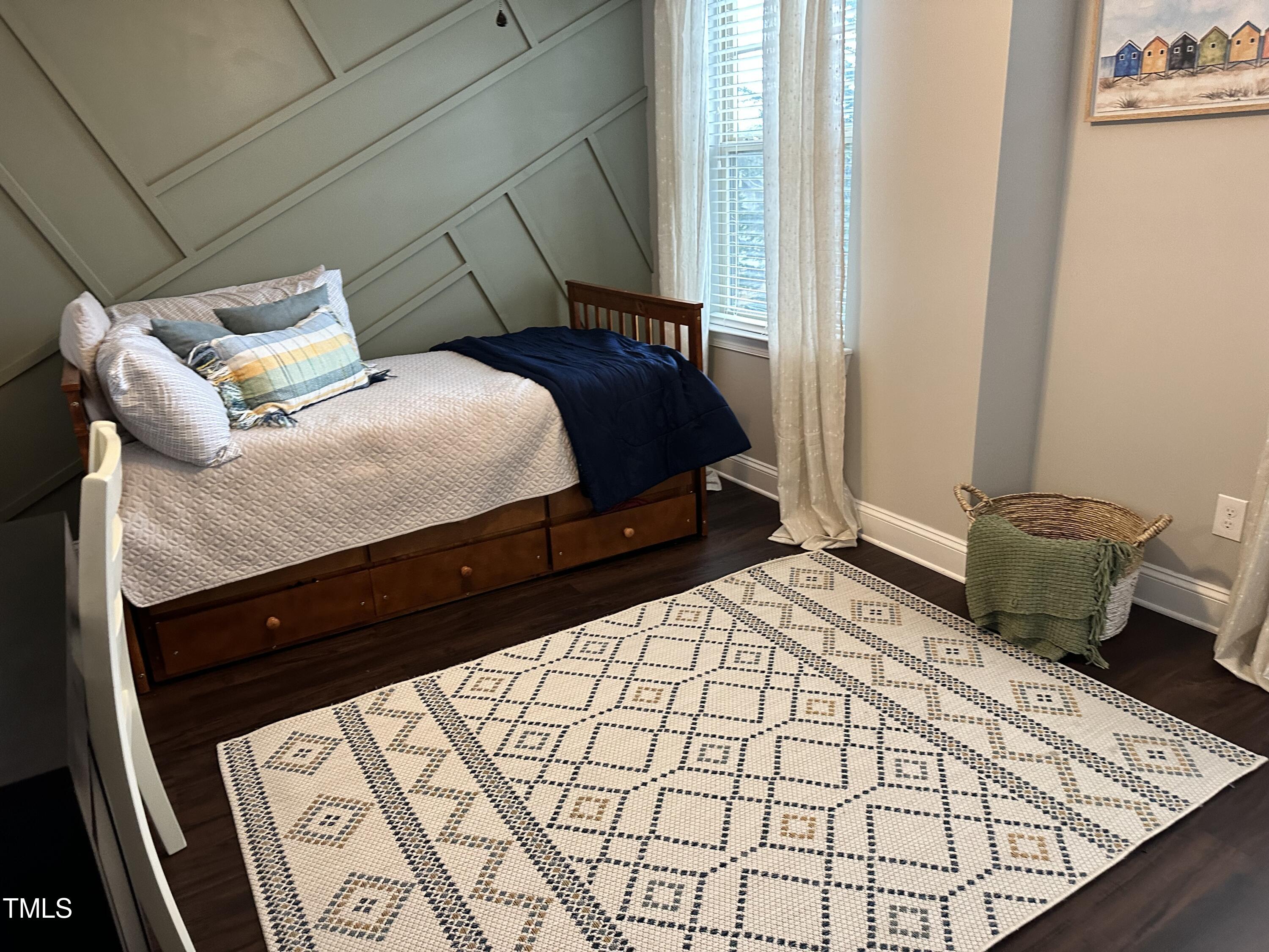 8305 Pin Cherry Drive Willow Spring, NC 27592 - Photo 37 of 60 a bedroom with a bed and wooden floor