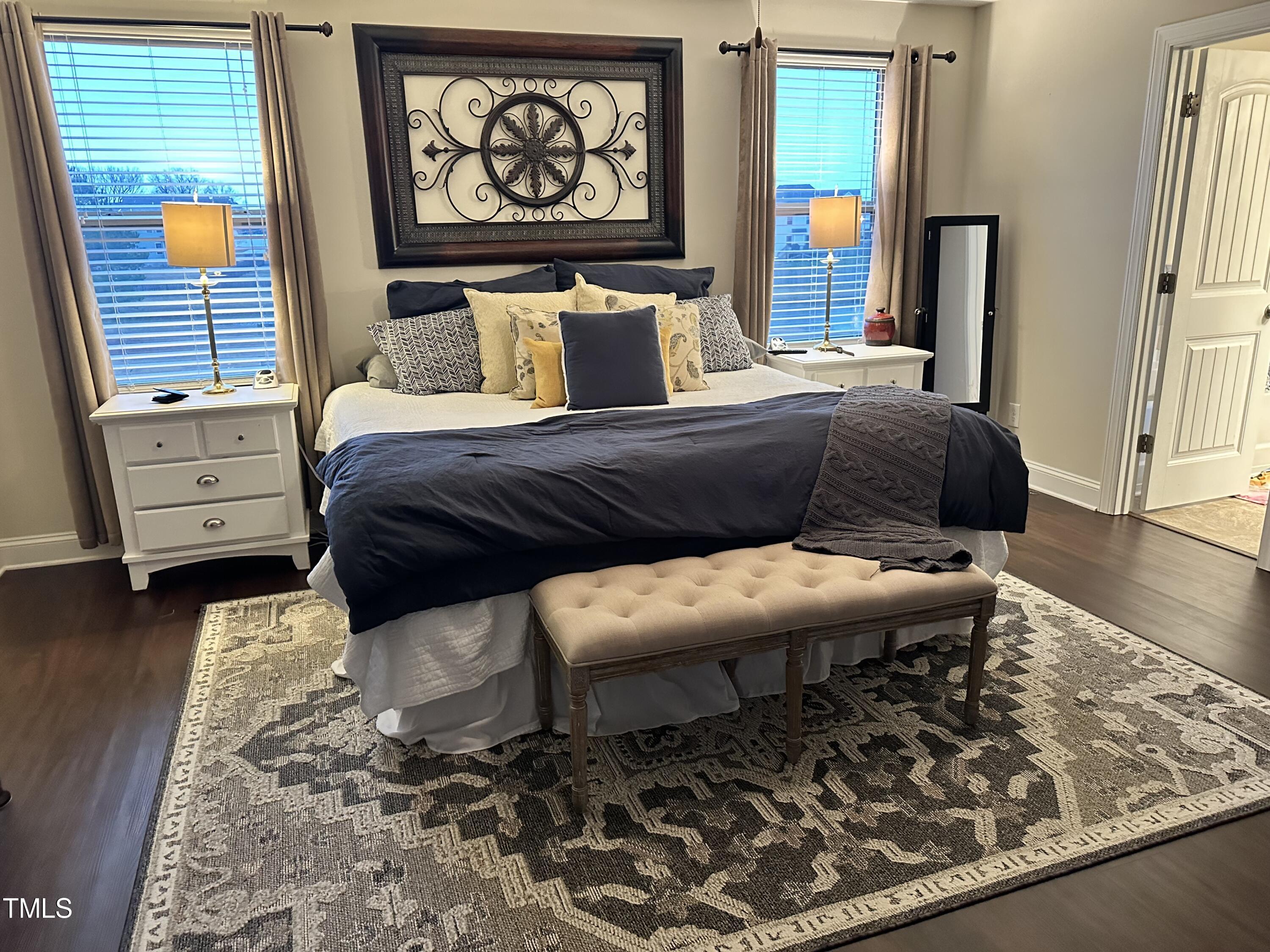 8305 Pin Cherry Drive Willow Spring, NC 27592 - Photo 39 of 60 a bedroom with a bed and wooden floor