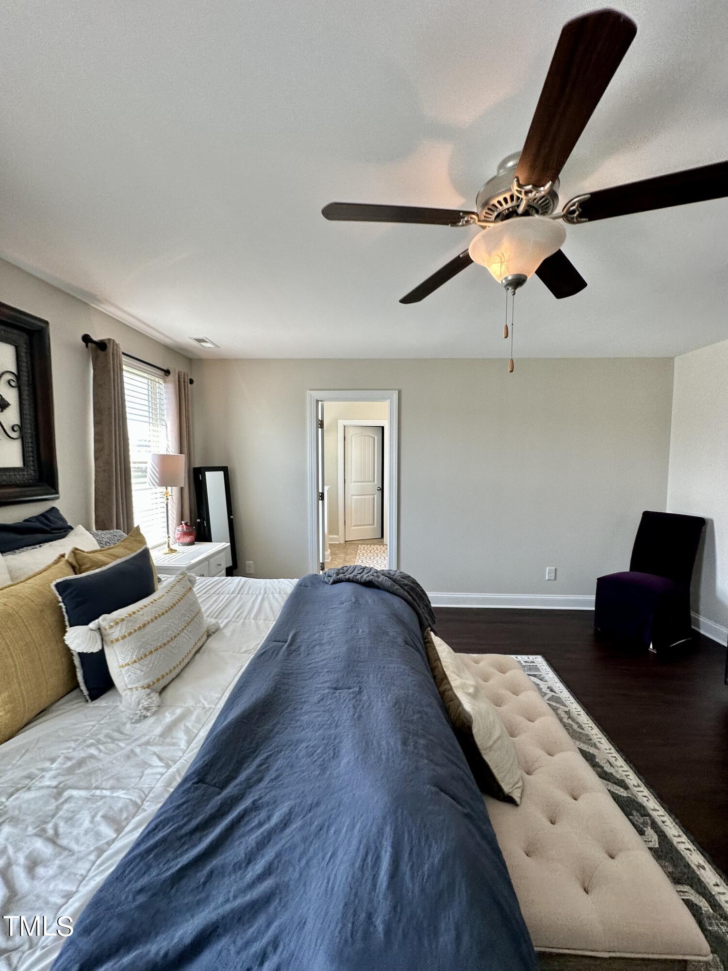 8305 Pin Cherry Drive Willow Spring, NC 27592 - Photo 42 of 60 a bedroom with a bed and wooden floor