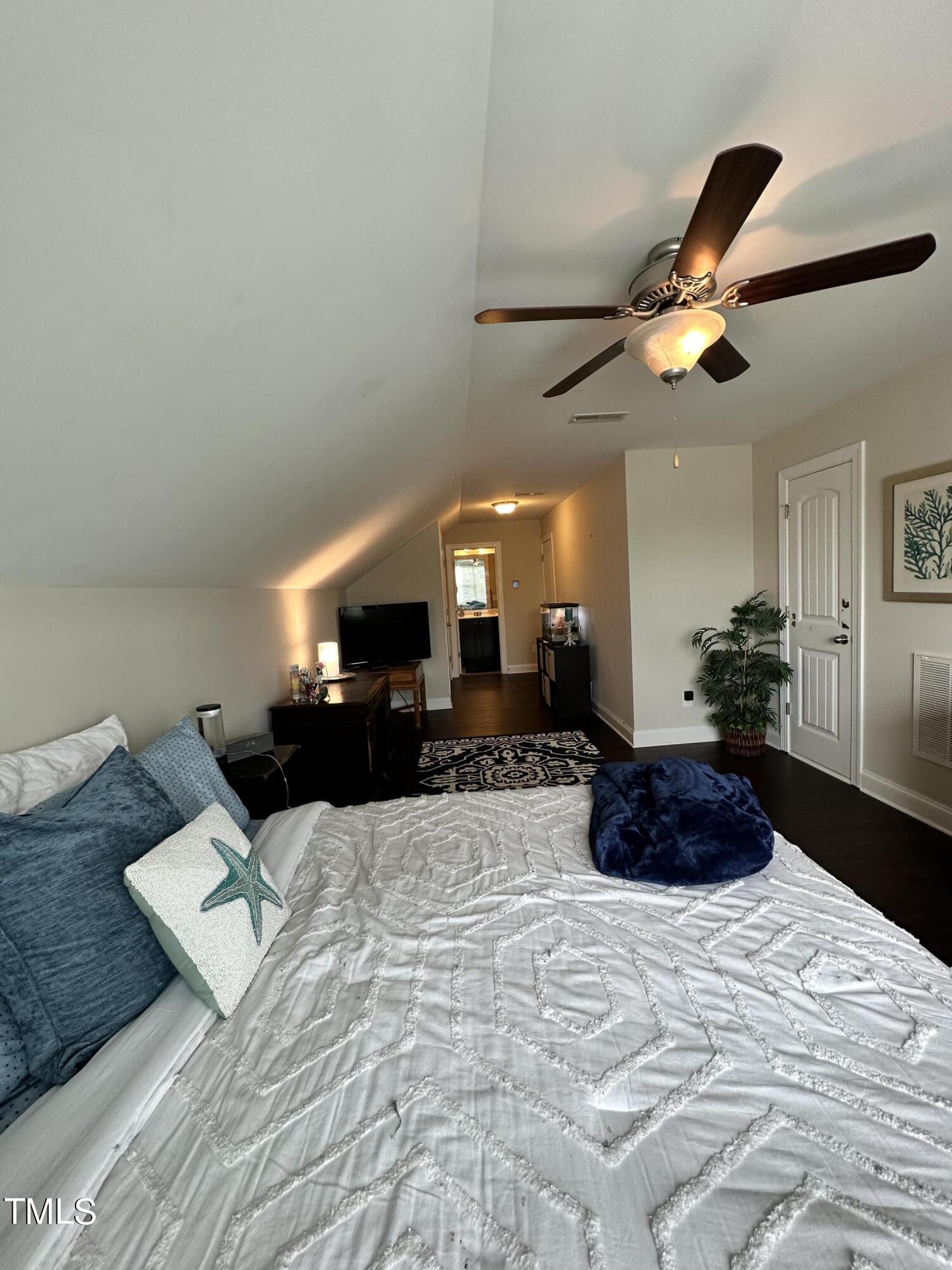 8305 Pin Cherry Drive Willow Spring, NC 27592 - Photo 50 of 60 a large white bed in a room next to a window